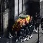 Pallbearers carry the coffin of Queen Elizabeth II, draped in the Royal Standard of Scotland, into St Giles' Cathedral, in Edinburgh, on September 12, 2022, for a service of Thanksgiving for her life. - Mourners will on September 12, 2022 get the first opportunity to pay respects before the coffin of Queen Elizabeth II, as it lies in an Edinburgh cathedral where King Charles III will preside over a vigil. (Photo by Oli SCARFF / AFP)