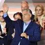 Hungarian Prime Minister Viktor Orban gestures alongside members of the Fidesz party during the EU elections, at Balna building in Budapest on June 9, 2024. Hungarian Prime Minister Viktor Orban's Fidesz party lost ground in the EU elections, partial results showed May 9, 2024, in what could be its worst-ever score in its 14-year rule. (Photo by Attila KISBENEDEK / AFP)