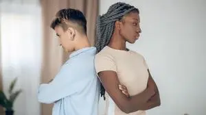 Conflict. Same sex couple having an argument and standing back to back