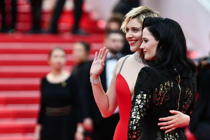 US director and president of the Jury of the 77th Cannes Film Festival Greta Gerwig (L) and French actress and model Eva Green arrive for the screening of the film "Furiosa: A Mad Max Saga" at the 77th edition of the Cannes Film Festival in Cannes, southern France, on May 15, 2024. (Photo by CHRISTOPHE SIMON / AFP)
