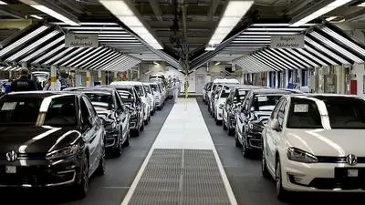 (FILES) A photo taken on October 21, 2015, shows employees of German car maker Volkswagen checking cars at a assembly line of the VW plant in Wolfsburg, central Germany. Allegations that Volkswagen lied about the carbon dioxide emissions of up to 800,000 cars evaporated into thin air on December 9, 2015, as the embattled German car maker said they had been proven to be largely unfounded.  AFP PHOTO / ODD ANDERSEN