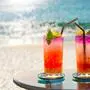 two colorful cocktails on the beach in summer