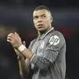 FILE - Real Madrid's Kylian Mbappe applauds fans at the end of the Champions League quarterfinal first leg soccer match between Arsenal and Real Madrid at the Emirates Stadium in London, Tuesday, April 8, 2025. Kylian Mbappé's legal team is going on the attack to try and solve the legal dispute between the World Cup winner and his former club PSG. (AP Photo/Frank Augstein, File)