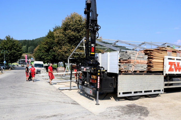 Bei glühender Hitze werden hunderte Tonnen an Gerüsten, Bodenplatten und schweren Eisenschienen bewegt.