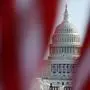 The U.S. Capitol is seen through a display of flags on the National Mall, one day after the inauguration of President Joe Biden, Thursday, Jan. 21, 2021, in Washington. (AP Photo/Rebecca Blackwell); Sujet