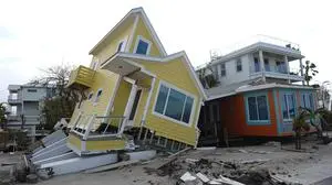 A house lies toppled off its stilts after the passage of Hurricane Milton, in Bradenton Beach on Anna Maria Island, Fla., Thursday, Oct. 10, 2024. (AP Photo/Rebecca Blackwell)