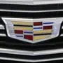FILE - This Thursday, Feb. 11, 2016, file photo shows the Cadillac logo, a General Motors Co. brand, on display on a vehicle at the Pittsburgh International Auto Show in Pittsburgh.   (AP Photo/Gene J. Puskar, File)