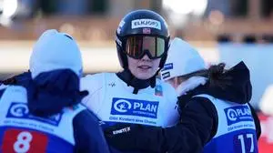 Anna Odine Stroem, of Norway, center, is met by her teammates after her second round jump at the women's ski jumping World Cup competition in Garmisch-Partenkirchen, Germany, Wednesday, Dec. 31, 2025. (AP Photo/Matthias Schrader)