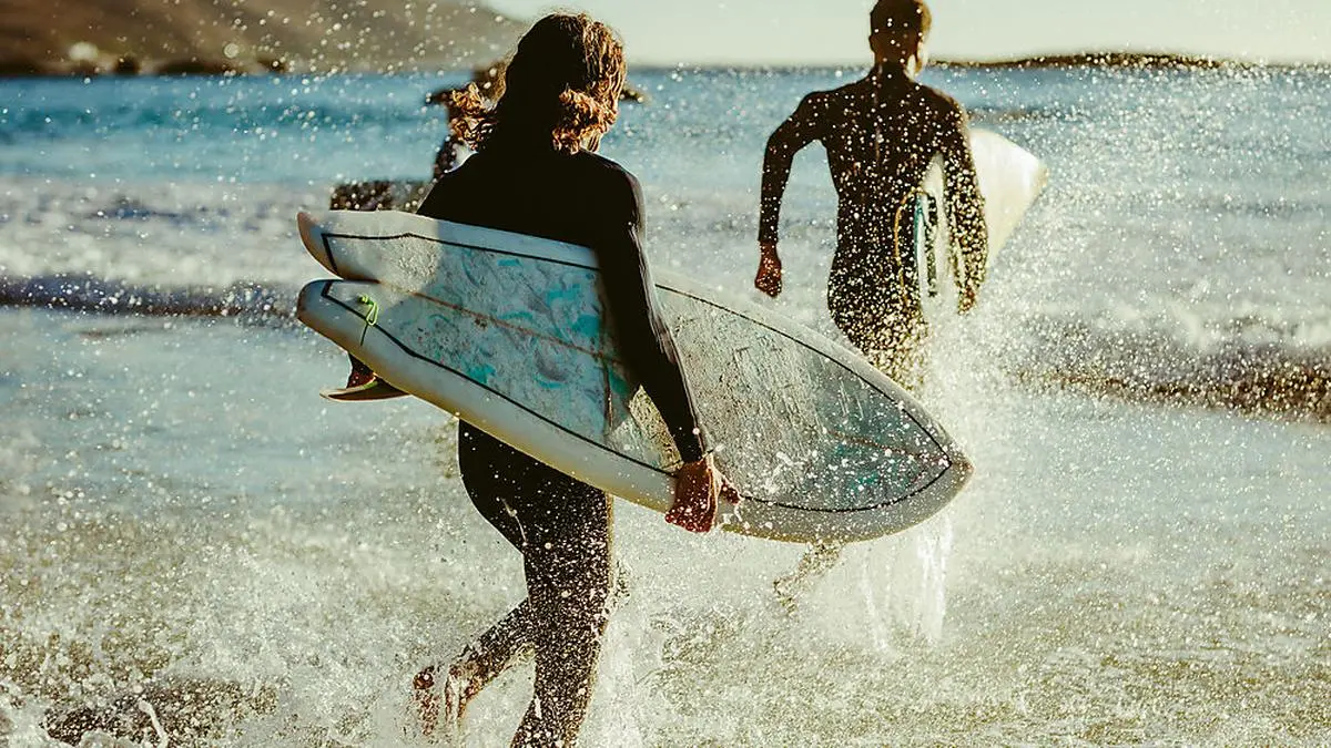 Surfers going for water surfing