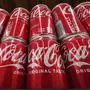 FILE - Cans of Coca-Cola are on display at a grocery market in Uniontown, Pa, April 24, 2022. (AP Photo/Gene J. Puskar, File)