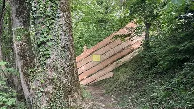 Ein durch einen Holzzaun abgesperrter Wanderweg