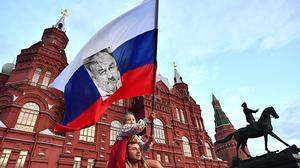 Ein russischer Fan feiert das Team mit Flagge und Tschertschessow-Konterfei