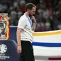 (FILES) England's head coach Gareth Southgate walks with his silver medal past to the trophy after  the UEFA Euro 2024 final football match between Spain and England at the Olympiastadion in Berlin on July 14, 2024. Gareth Southgate said he is resigning as England manager on July 16, 2024 two days after they lost to Spain in the Euro 2024 final. "It's time for change, and for a new chapter. Sunday's final in Berlin against Spain was my final game as England manager," he said in statement. (Photo by JAVIER SORIANO / AFP)