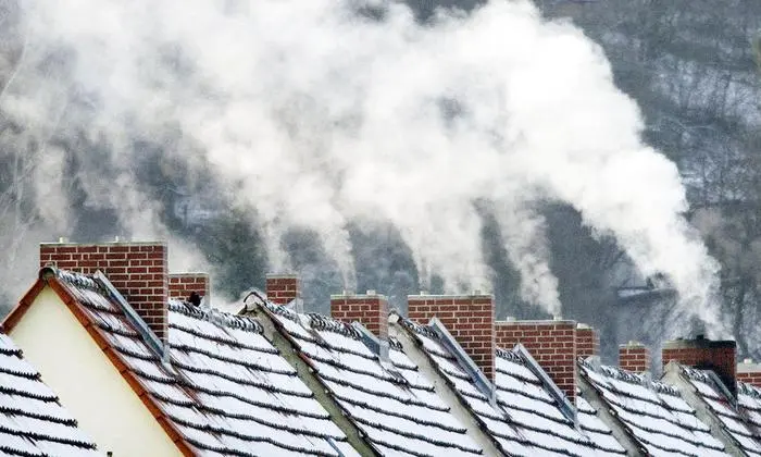Smoke slowly billows from the chimney stacks on houses in Erfurt, Germany, Wednesday Dec. 11, 2002. Despite the sun shining almost all day, temperatures are frosty in Germany. First snow is expected in the Erfurt region for the upcoming weekend. (AP Photo/Jens Meyer)