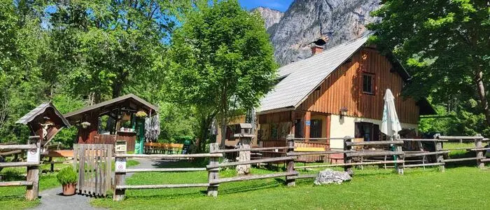 Eine urige Hütte steht auf einer grünen Wiese