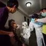 A medical worker takes o by STR / AFP) / China OUT