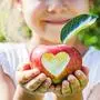 Child with an apple. Selective focus. Garden Food