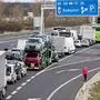 Drivers wait in the traffic jams on the A4 motorway towards Hungary, before the Nickelsdorf/Hegyeshalom border between Austria and Hungary on March 14, 2020 as border controls have been implemented to limit the spread of the novel coronavirus. - So far, Hungary has confirmed 19 cases of infections, nine of them Iranians (mostly university scholarship-holders), one British national, and the rest Hungarians. (Photo by ALEX HALADA / AFP)