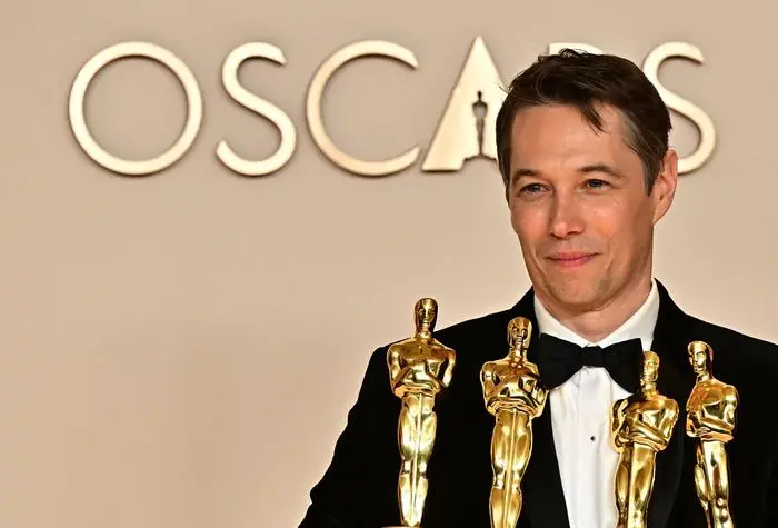 US producer Sean Baker poses in the press room with the Oscars for Best Film Editing, Best Original Screenplay, Best Director and Best Picture for 