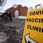 People line up for a COVID-19 vaccination clinic that was hosted by Rescue Inc. at Bellows Falls Fire Department, Friday, Jan. 14, 2022, in Bellows Falls, Vt. (Kristopher Radder/The Brattleboro Reformer via AP)