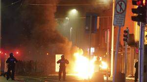 Mehrere Streifenwagen brannten in Dublin. Einige Polizisten mussten sich bis zum Eintreffen von Verstärkung verschanzen 