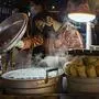 A street vendor prepares steamed delicacies in Wuhan on Sunday, Oct. 18, 2020. (AP Photo/Ng Han Guan)