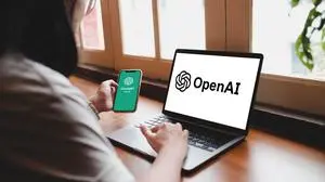 Bangkok, Thailand. June 8, 2025; Woman using a smartphone with the ChatGPT app and a laptop with the OpenAI logo, showing interaction with artificial intelligence chatbot technology.