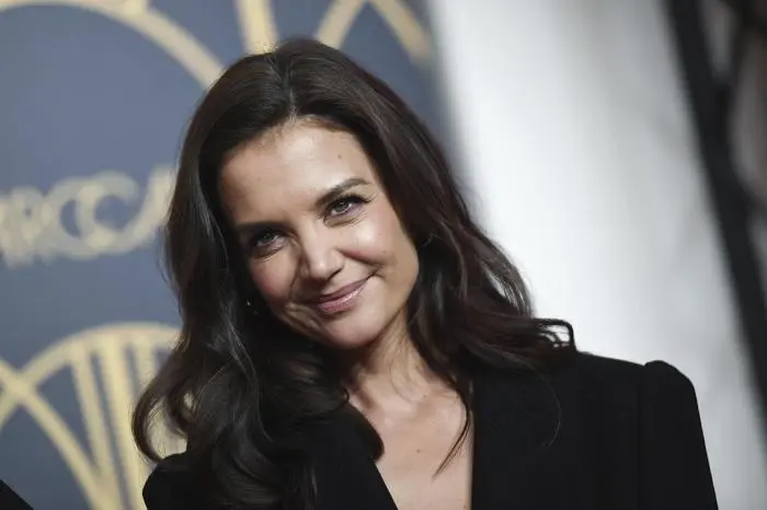 US actress Katie Holmes poses for the media before the show for the label Marc Cain, as part of Berlin Fashion Week in Berlin, Tuesday, Jan. 14, 2020. (Britta Pedersen/dpa via AP)