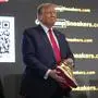 Republican presidential candidate former President Donald Trump holds gold Trump sneakers at Sneaker Con Philadelphia, an event popular among sneaker collectors, in Philadelphia, Saturday, Feb. 17, 2024. (AP Photo/Manuel Balce Ceneta)