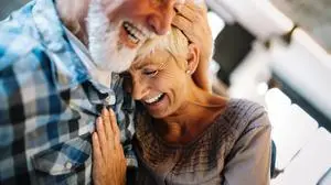 Happy smiling senior couple in love hugging and bonding with true emotions at home