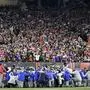 Buffalo Bills players and staff pray for Buffalo Bills' Damar Hamlin during the first half of an NFL football game against the Cincinnati Bengals, Monday, Jan. 2, 2023, in Cincinnati. The game has been postponed after Buffalo Bills' Damar Hamlin collapsed, NFL Commissioner Roger Goodell announced. (AP Photo/Joshua A. Bickel)