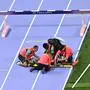 TOPSHOT - Ethiopia's Lamecha Girma receives medical attention during the men's 3000m steeplechase final of the athletics event at the Paris 2024 Olympic Games at Stade de France in Saint-Denis, north of Paris, on August 7, 2024. (Photo by Ben STANSALL / AFP)