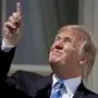 FILE - In this Aug. 21, 2017, file photo, President Donald Trump points to the sun as he arrives to view the solar eclipse at the White House in Washington. Trump's comment about injecting disinfectant to fight coronavirus is just the latest in a long list of comments and actions that run contrary to mainstream science. He's gone against scientific and medical advice by staring at an eclipse without protection, calling climate change a hoax and saying wind turbines cause cancer.  (AP Photo/Andrew Harnik, File)