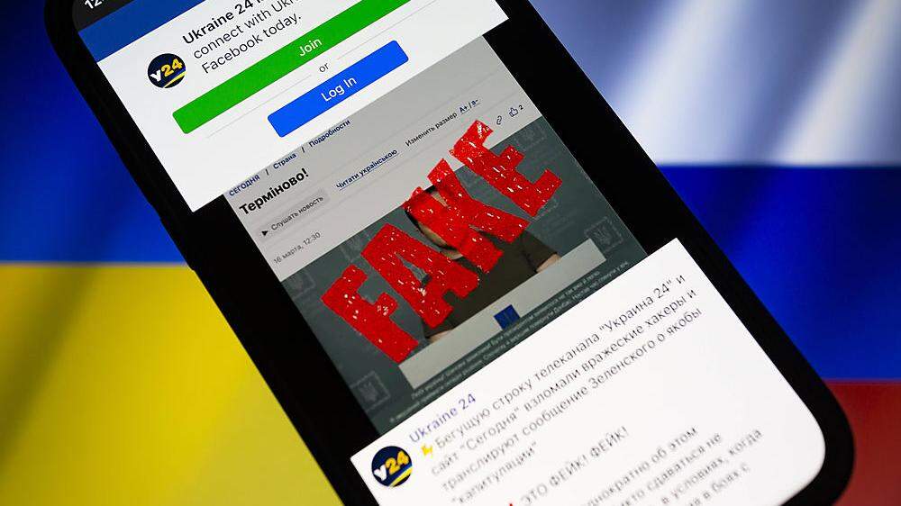 March 17, 2022, Asuncion, Paraguay: Illustration: Ukraine 24 Facebook page is displayed on a smartphone backdropped by c