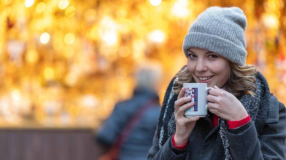 Weihnachtsmärkte und Glühwein in Graz: Junge Frau mit Punsch-Häferl | Von traditionell bis schrill: Die Grazer Weihnachtsmärkte bieten für alle etwas