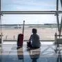 Bub sitzt auf Flughafen und schaut auf das Rollfeld. Neben ihm steht sein Koffer. | Der Zehnjährige sollte am Flughafen auf seine Verwandten warten (Symbolbild)