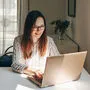Girl working using laptop in home office