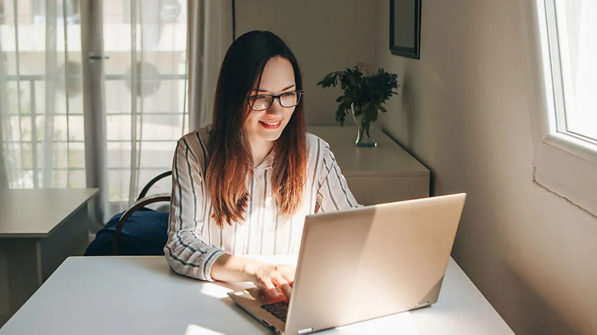 Girl working using laptop in home office