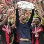 FILE - Leverkusen's head coach Xabi Alonso celebrates with the trophy as his team won the German Bundesliga, after the German Bundesliga soccer match between Bayer Leverkusen and FC Augsburg at the BayArena in Leverkusen, Germany, Saturday, May 18, 2024. Toni Kroos has been voted Germany’s player of the year for 2023/24 while Xabi Alonso won the coach’s accolade for leading Bayer Leverkusen to the Bundesliga title. (AP Photo/Martin Meissner, File)
