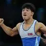 North Korea's Ri Se Ung reacts to his win over Venezuela's Raiber Jose Rodriguez Orozco in their men's greco-roman 60kg wrestling bronze medal match at the Champ-de-Mars Arena during the Paris 2024 Olympic Games, in Paris on August 6, 2024. (Photo by Luis ROBAYO / AFP)