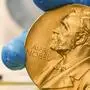 FILE- In this file photo dated Friday, April 17, 2015, a national library employee shows the gold Nobel Prize medal awarded to the late novelist Gabriel Garcia Marquez, in Bogota, Colombia. The Nobel prize has greater personal impact than merely receiving the monetary award, as it marks the recipient in terms of esteem and global recognition. (AP Photo/Fernando Vergara, FILE)