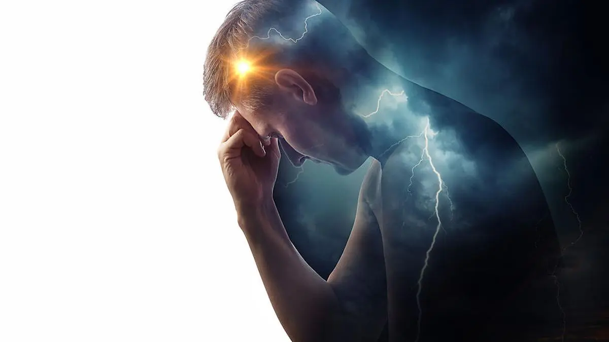 Storm sky with lightning and sun on the background of the silhouette of a man. Concept on the theme of the struggle between good and evil or the theme of medicine (migraine and headache pain ). Health and pain.