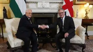 (FILES) Britain's Prime Minister Keir Starmer (R) shakes hands with Palestinian president Mahmud Abbas (L) at the beginning of their meeting at 10 Downing Street in London on September 8, 2025. Britain on Sunday, September 21, has recognised a Palestinian state with a landmark announcement due from Prime Minister Keir Starmer, as several nations were poised to follow at UN talks to pressure Israel over the Gaza war. (Photo by Jonathan Brady / POOL / AFP)
