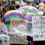 People attend a 'Fridays For Future' protest rally at the Brandenburg Gate in Berlin, Germany, Friday, Sept. 25, 2020. (AP Photo/Michael Sohn)