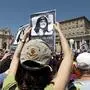 FILE - In this Sunday, May 27, 2012 file photo, people hold pictures of Emanuela Orlandi reading, "march for truth and justice for Emanuela" in St. Peter's square, at the Vatican. An expert for the family of a Vatican teenager who went missing in 1983 says there are thousands of bones in an underground space near a Vatican cemetery. Giorgio Portera, engaged by Emanuela Orlandi’s family, said the extent of the cache emerged Saturday when Vatican-appointed experts began cataloguing the remains discovered on July 13. Portera said skulls and bones appear to belong to dozens of individuals. The Vatican made no mention of the number but said analyses would resume on July 27. (AP Photo/Andrew Medichini, File)