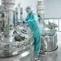 Pharmaceutical technician in sterile environment at pharmacy industry