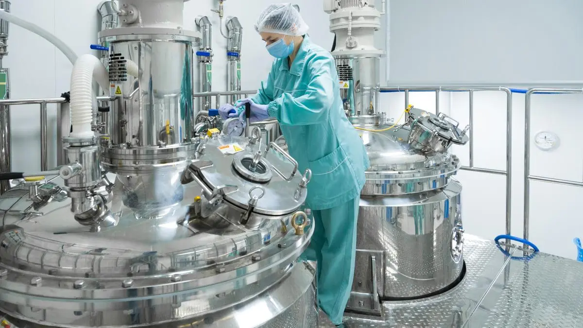 Pharmaceutical technician in sterile environment at pharmacy industry