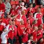 Denmark fans chant in support of Denmark's midfielder Christian Eriksen after he collapsed during the UEFA EURO 2020 Group B football match between Denmark and Finland at the Parken Stadium in Copenhagen on June 12, 2021. (Photo by WOLFGANG RATTAY / POOL / AFP)