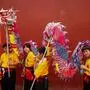 TOPSHOT - Children wait to perform a dragon dance near the A-Ma temple during celebrations of Kuan Tai in Macau on August 10, 2023. (Photo by Eduardo Leal / AFP)