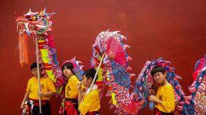 TOPSHOT - Children wait to perform a dragon dance near the A-Ma temple during celebrations of Kuan Tai in Macau on August 10, 2023. (Photo by Eduardo Leal / AFP)